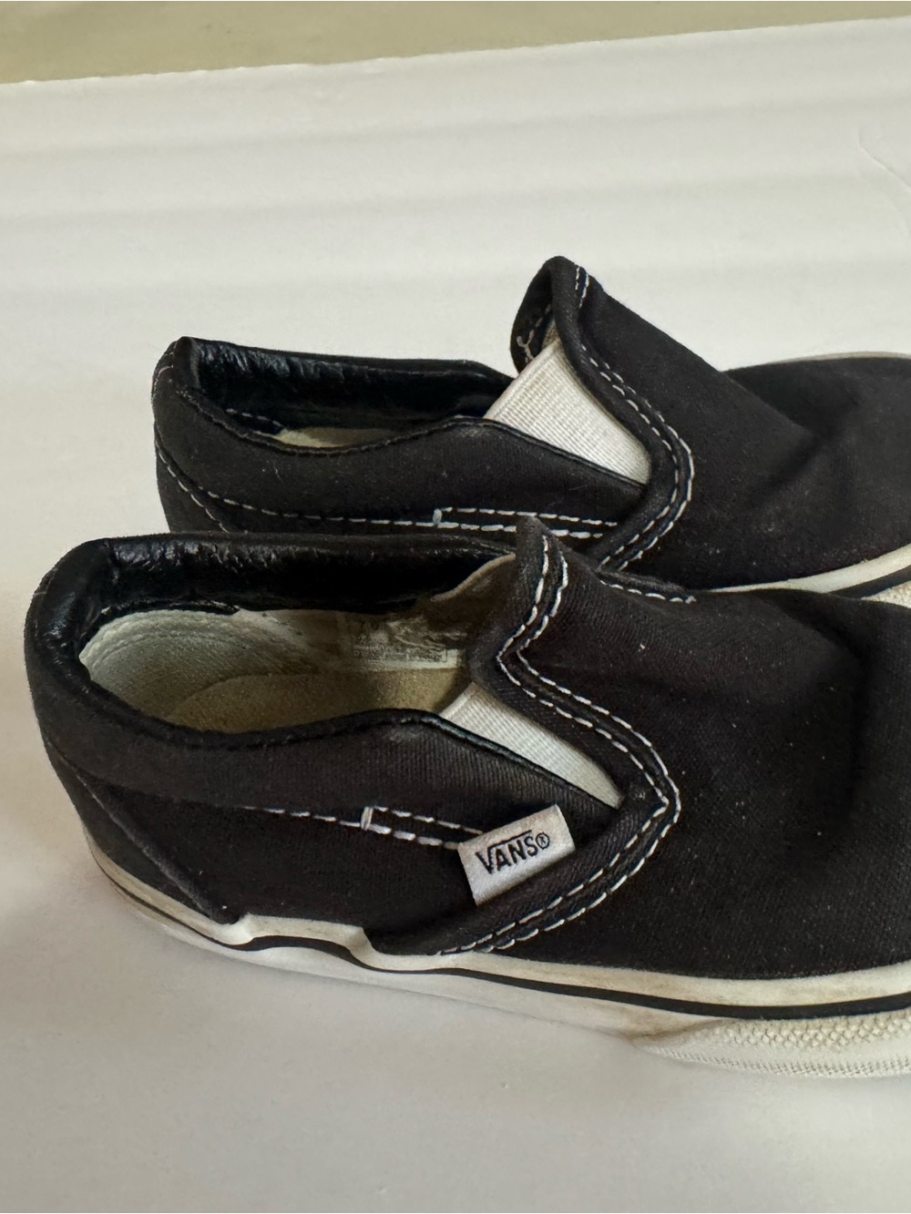 Vans Kids Slip-On Canvas Sneakers in Black and White